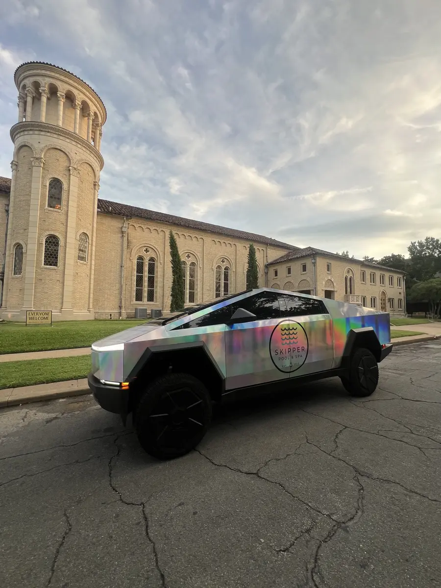 Skipper Cybertruck parked by a historic church