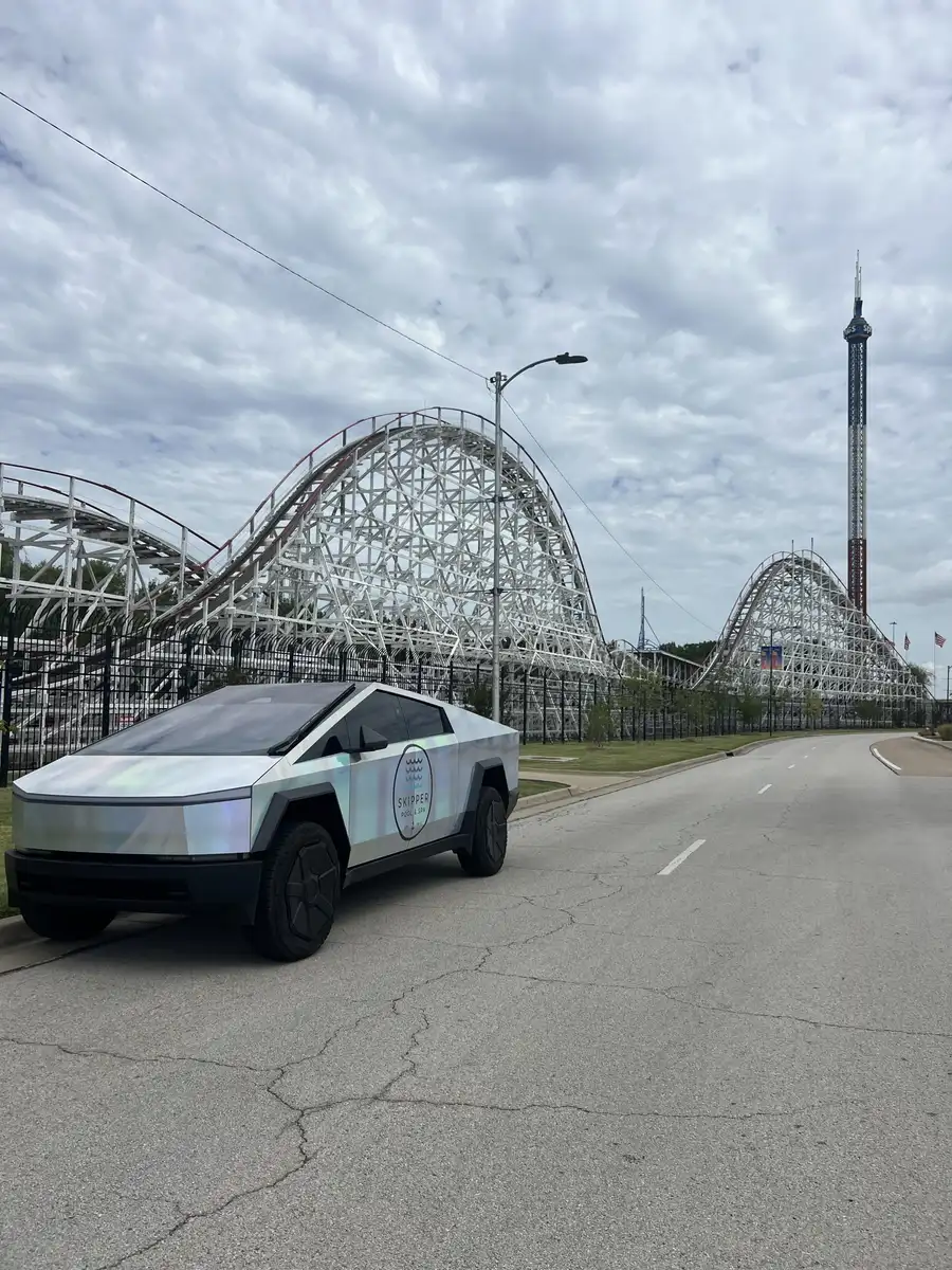 Skipper Cybertruck with a wooden roller coaster behind it