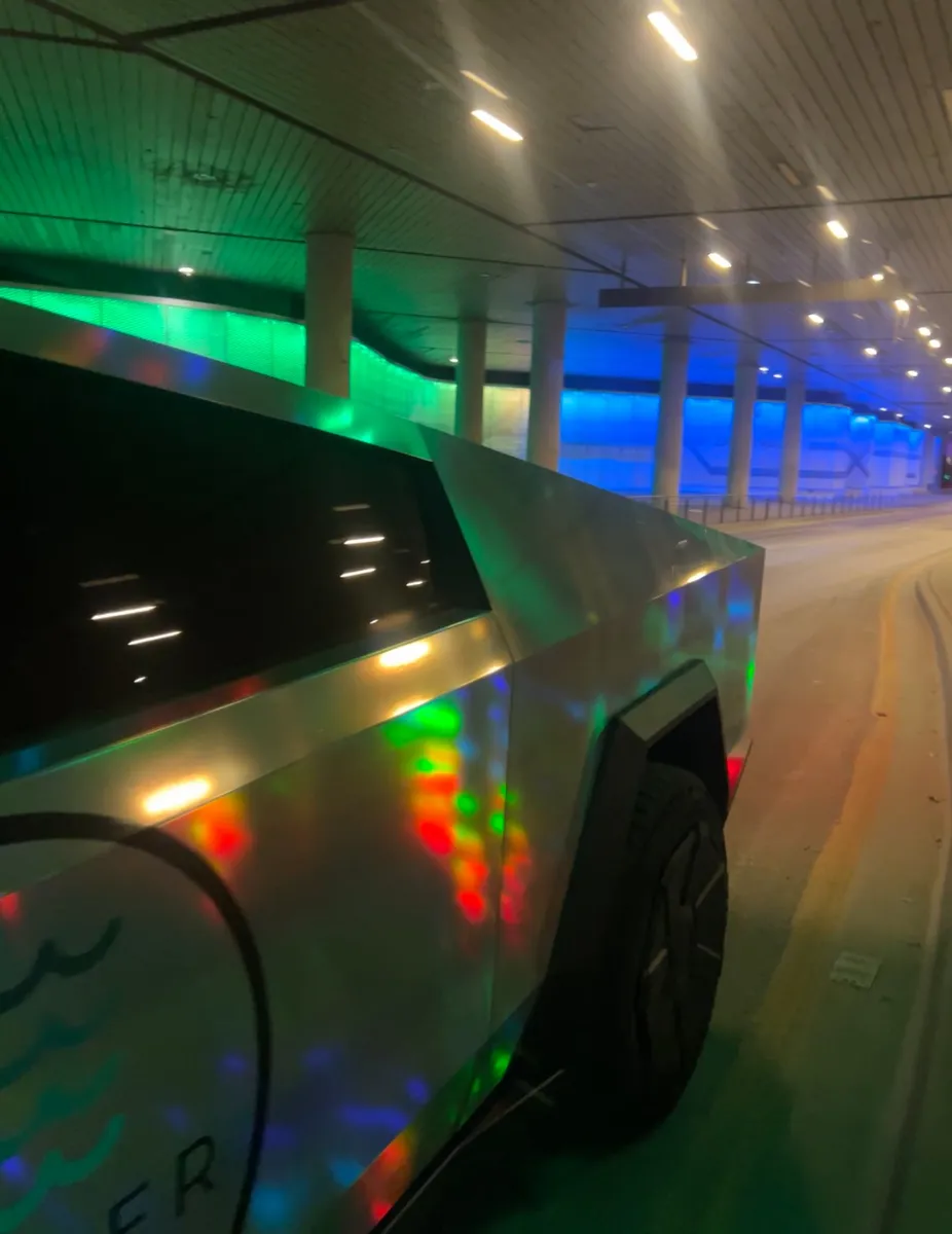 Holographic Skipper Cybertruck in a lit underpass at night
