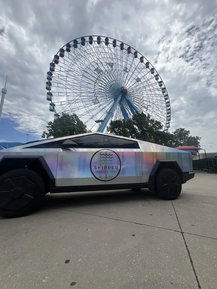 Skipper Cybertruck side view with the Texas Star Ferris wheel