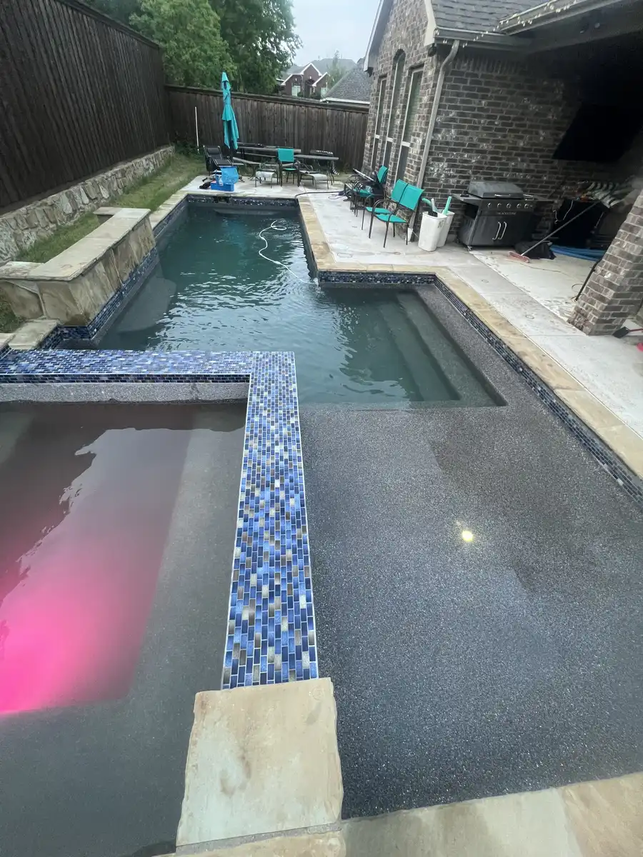Clear pool with a pink-lit spa