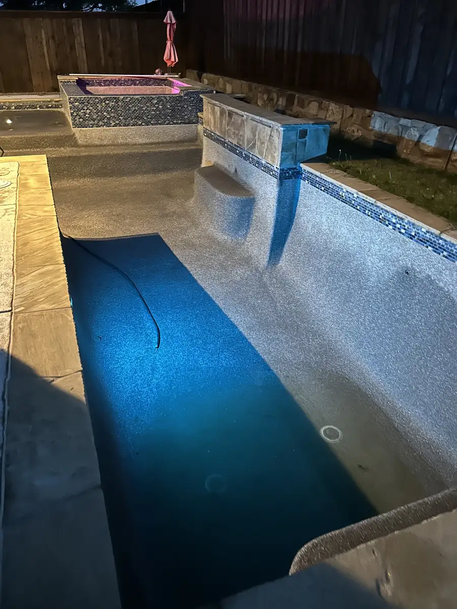 Empty pool with a blue light at night