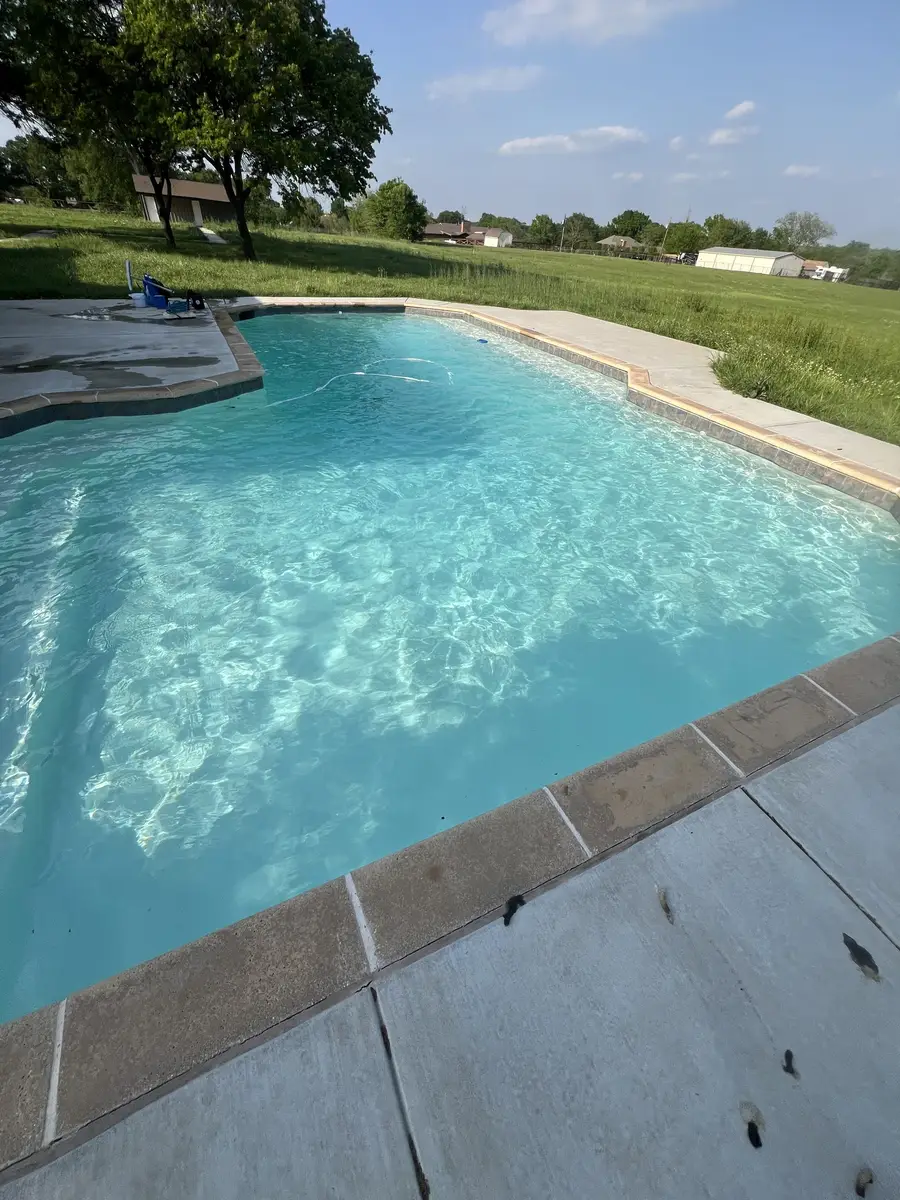 Clear pool with an open lawn view