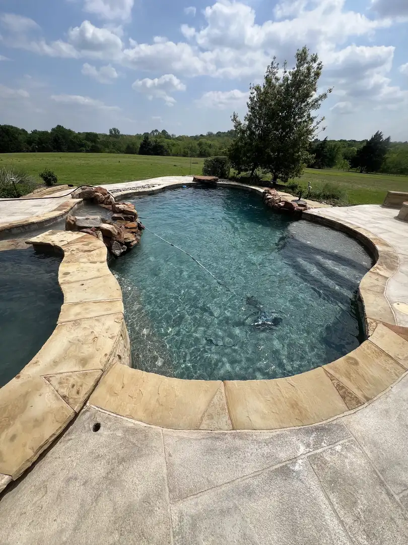 Freeform pool with rockwork and lawn