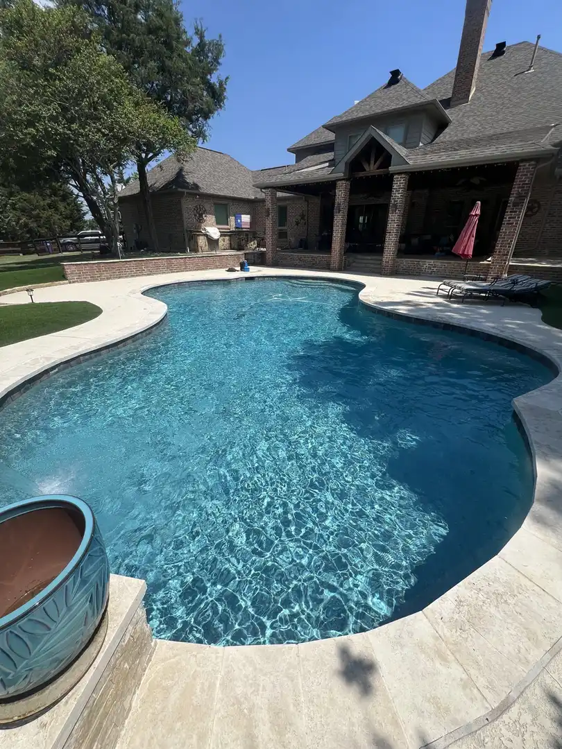 Freeform pool by a large home