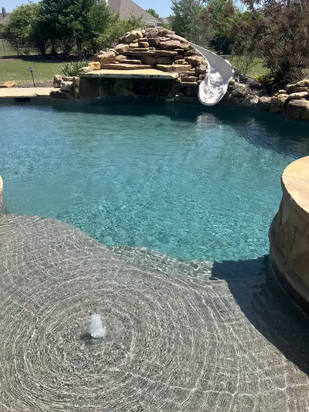 Pool with a pebble beach entry
