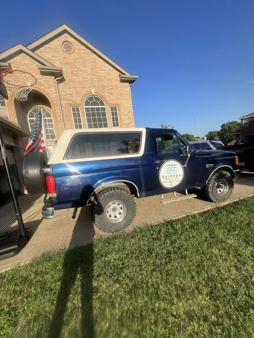 Navy and white Skipper Bronco with the flag