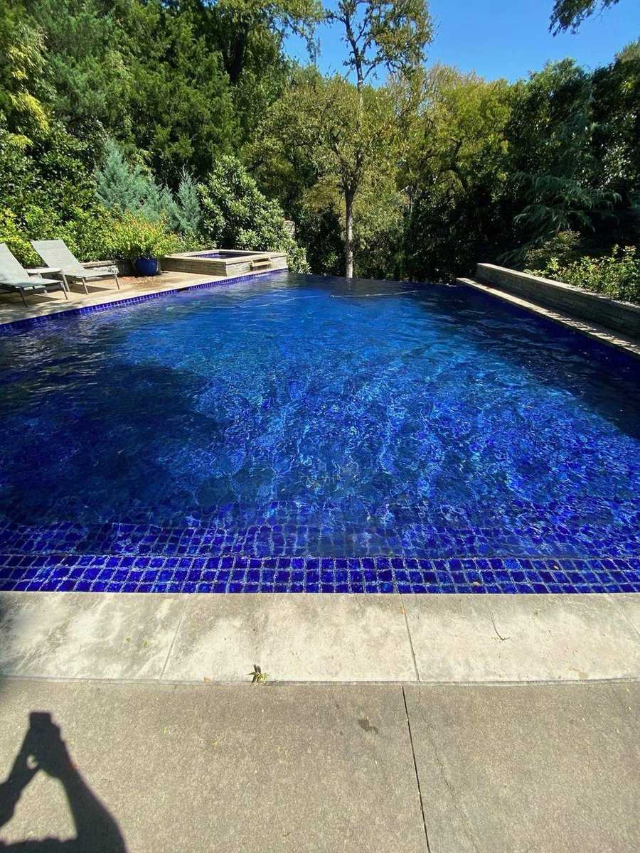 Cobalt mosaic infinity edge pool with raised spa spillover