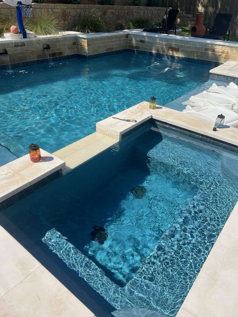 Modern spa with tanning ledge and sheer descent waterfalls