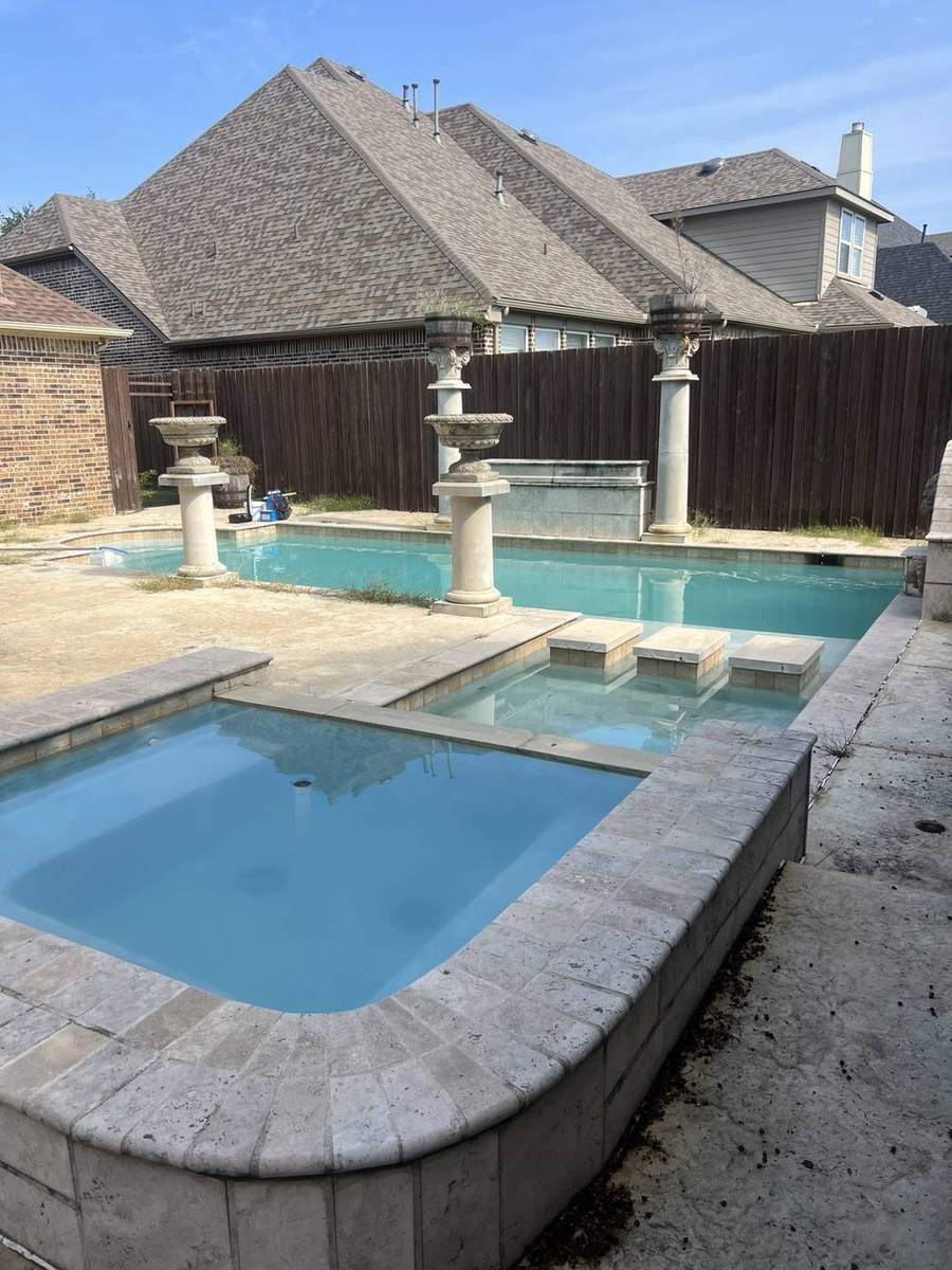 Clear spa and rectangular pool with stone columns