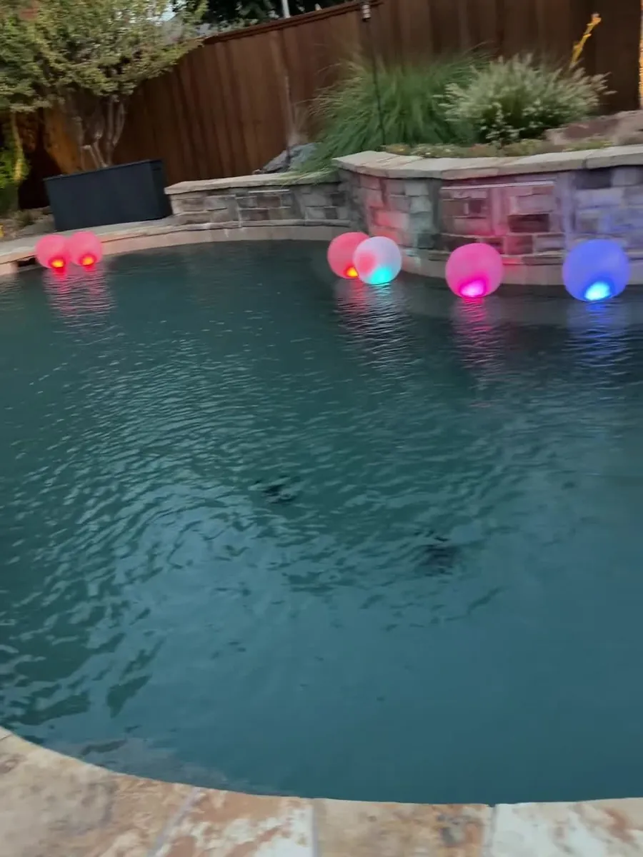 Pool at night with colorful floating lights