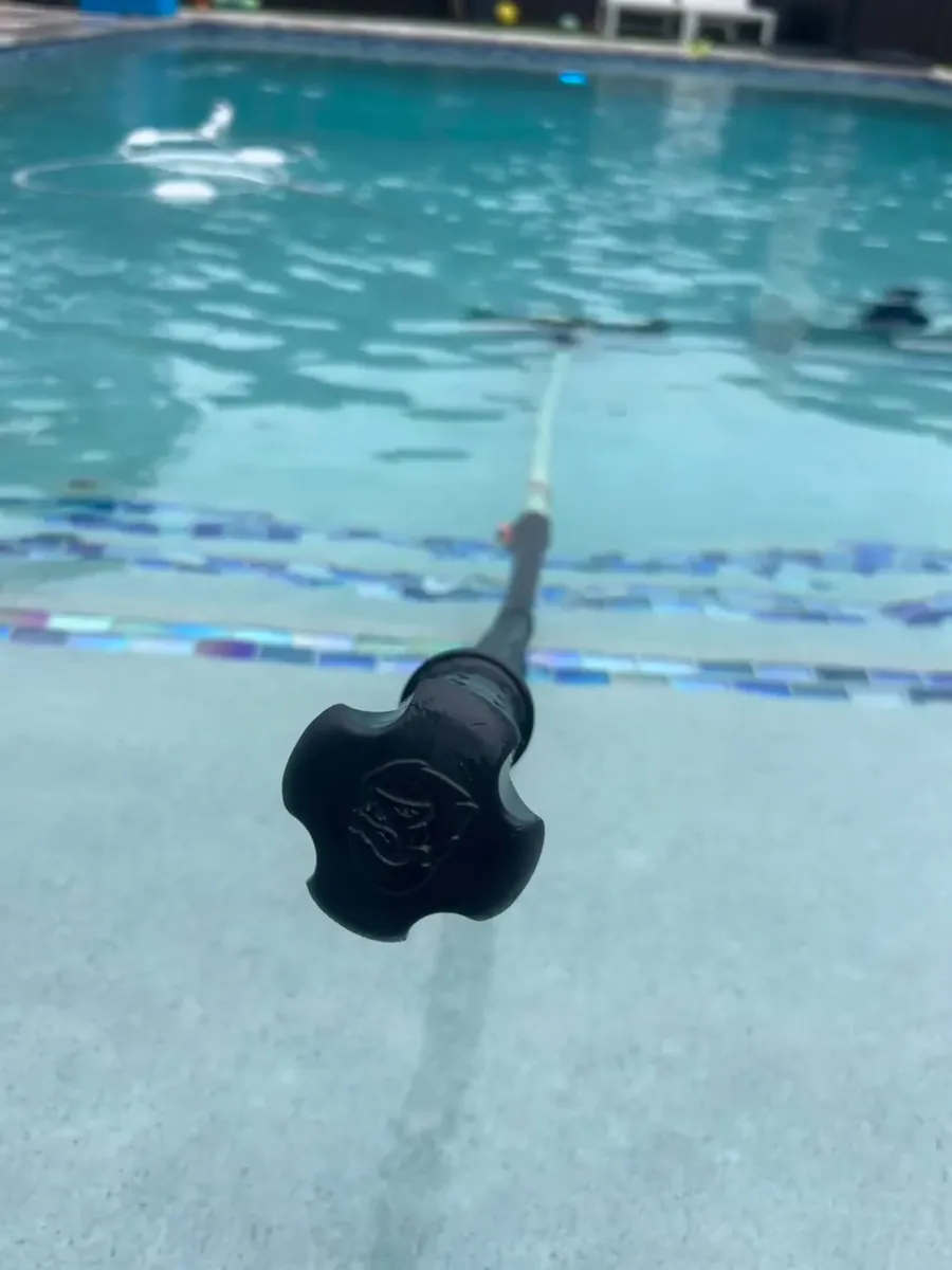 Vacuum head on the pole in clear water